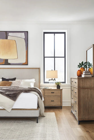 Modern bedroom with wooden furniture, artwork on the wall, and decorative elements.