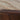 Tanidore Round Coffee Table - Warm Brown